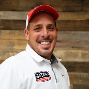 Headshot of field supervisor, Juan DiMatteo, taken at the San Antonio office. He is smiling and wearing a white Baird sports shirt.