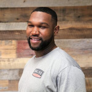 Headshot of co-foreman, Victor Evans, taken at the San Antonio office. He is smiling and wearing a grey Baird t-shirt.