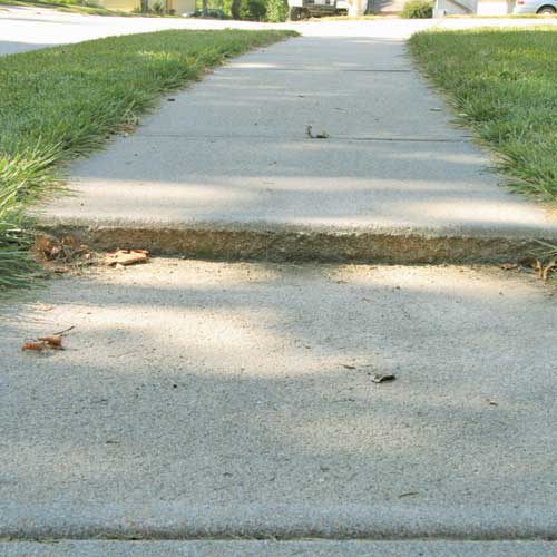 concrete sidewalk expansion joint that has raised and is creating a large trip hazard