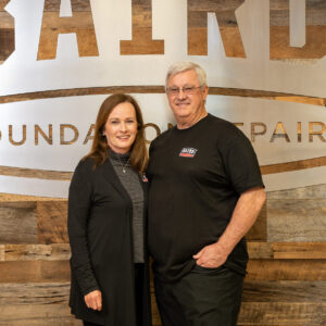 Company owners, John & Melanie Chaney, smile for a photo in the Baird Foundation Repair San Antonio office.