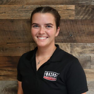 Headshot of foreman, Courtney Bigley, taken in the San Antonio office. She is smiling and wearing a black Baird Foundation Repair polo shirt.