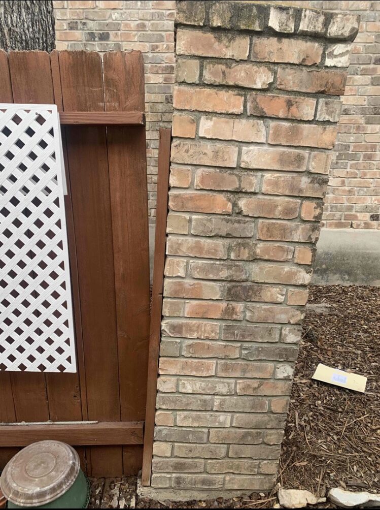 brick fence pillar outside a home leaning severely