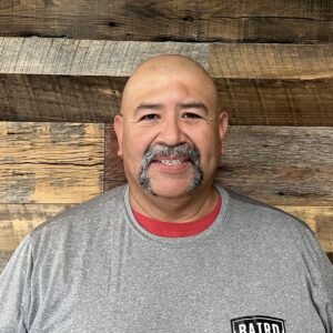San Antonio warehouse assistant smiles for headshot