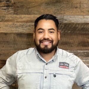 Foreman smiles for his headshot at Baird's office