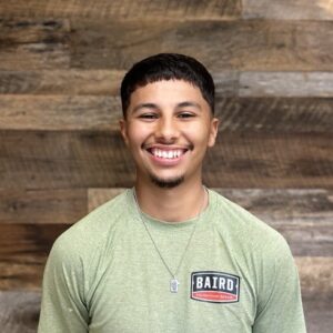San Antonio Co-Foreman smiles for his headshot at Baird's office