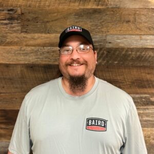 Warehouse assistant smiles for his headshot