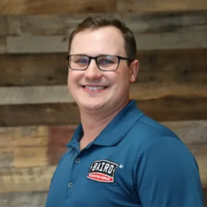 Kelby, Sr System Design Specialist smiles for his headshot in the San Antonio Office.