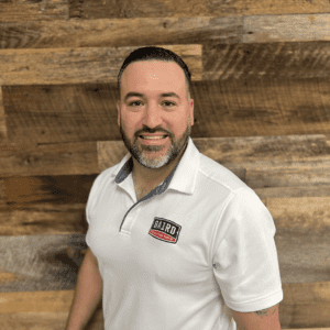 sales director smiles for is headshot
