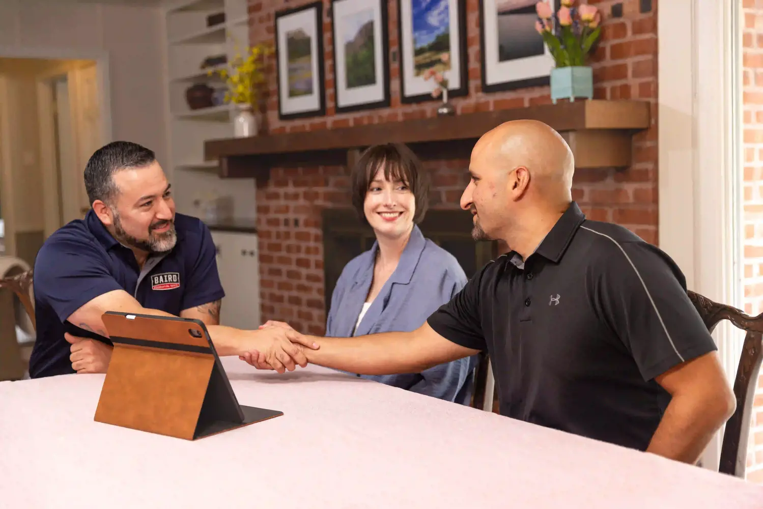 2025-Baird-Marketing-Pics-Appointment-and-Inspection-127-HiRes (1) (1) Homeowners shaking hand with Baird inspection team member reviewing repair policy.