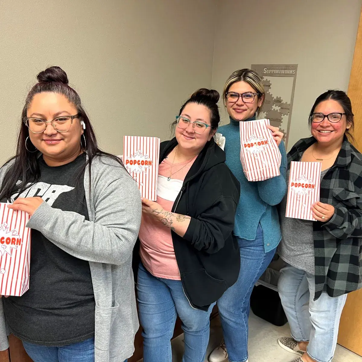 Office employees smile for national popcord day