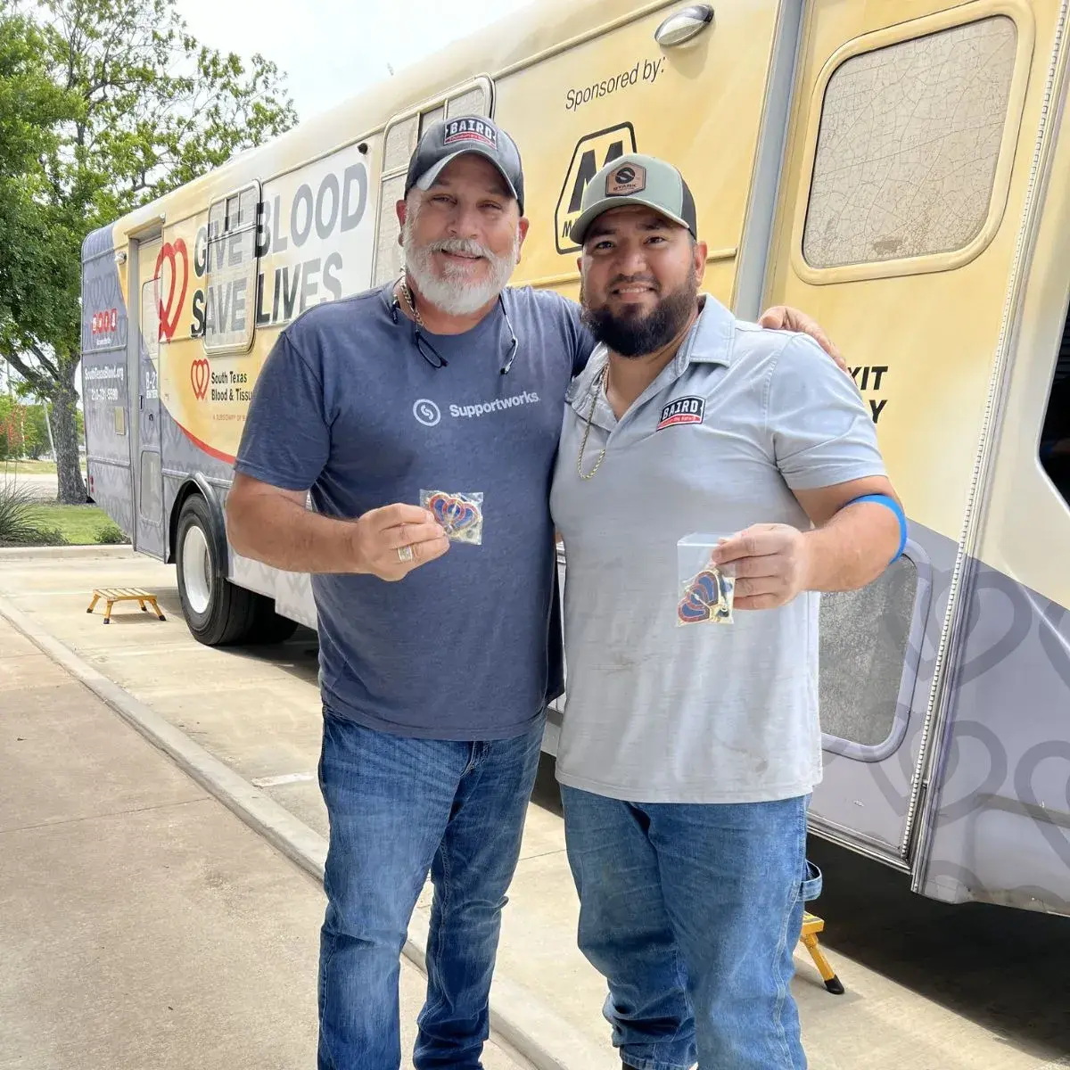 team members smile after donating blood.