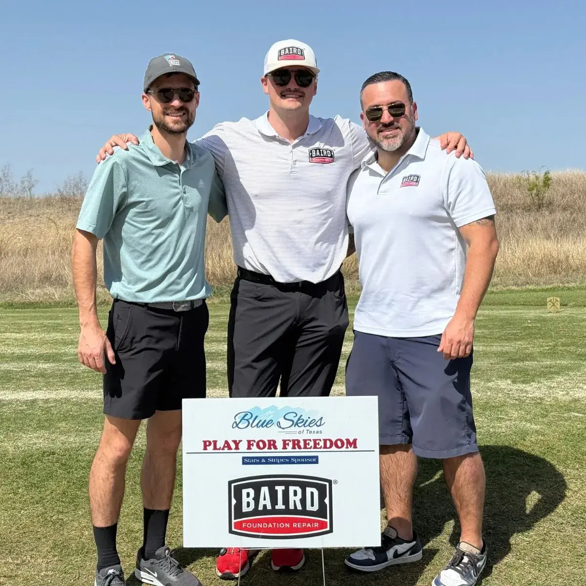 team members at golf tournament
