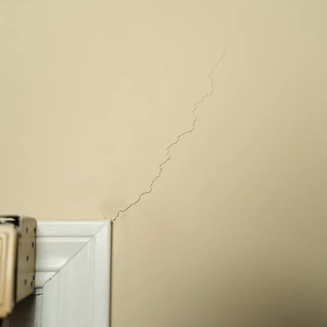 Diagonal cracks extending from door showing signs of foundation issues