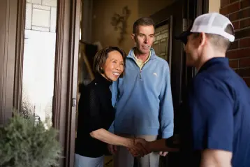 System Design Specialist shakes homeowner hand