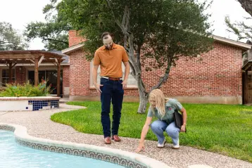 Houston System Design Specialist showing homeowner problems with their pool deck