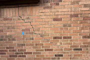 Home with exterior cracks, showing signs of foundation issues.