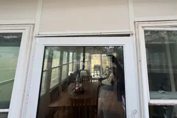 Sunroom foundation damage in Cibolo, TX with visible gap and cracking above window prior to helical pier installation.