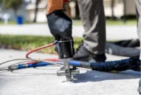 Upclose Concrete Foam Gun in concrete.