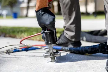 Upclose Concrete Foam Gun in concrete.