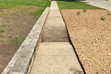 Alamo Heights sidewalk concrete with a portion of sinking